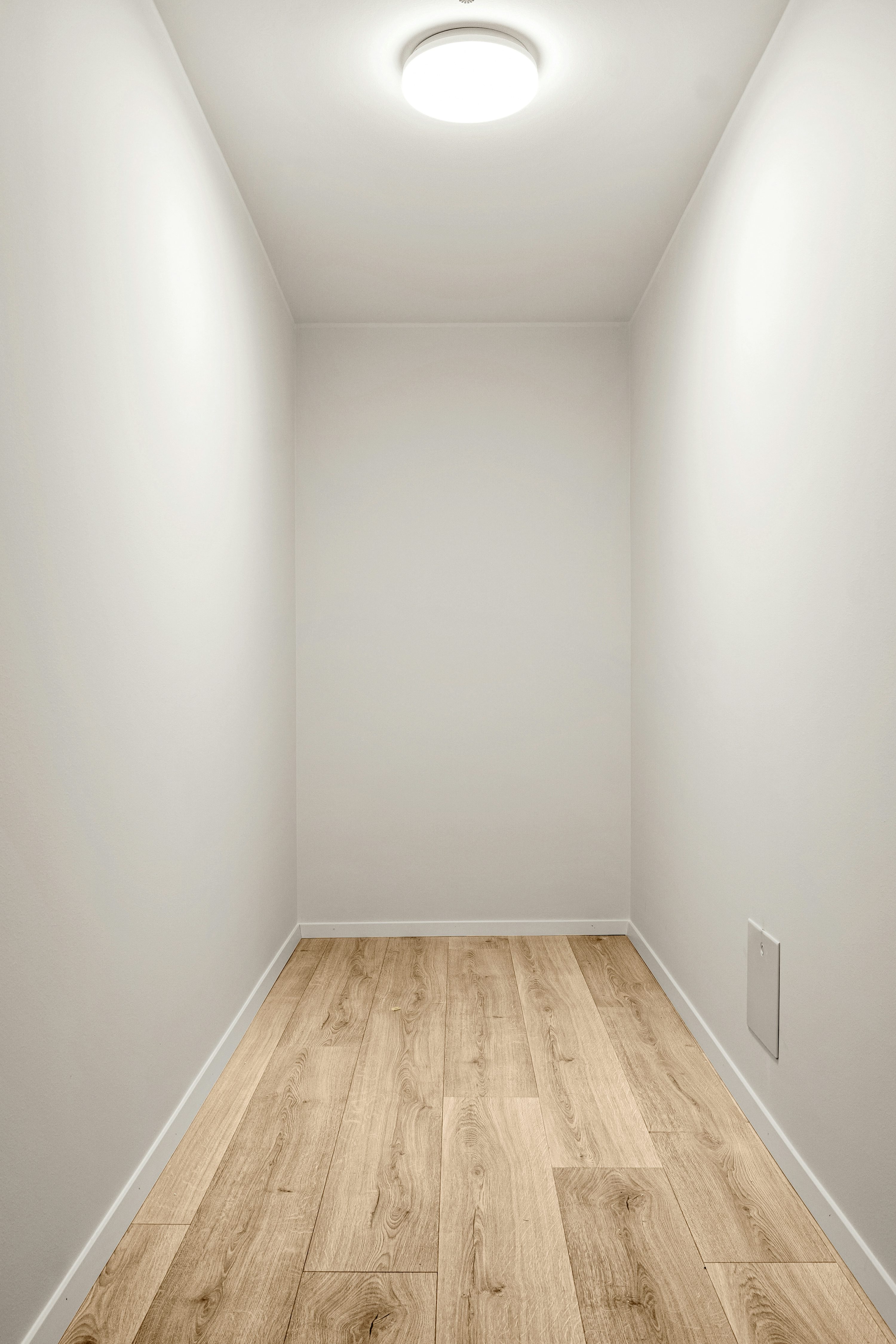 Empty interior, wooden floor, white walls